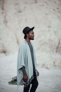 Young man wearing hat standing outdoors