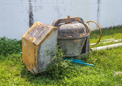 Close-up of old rusty pipe on field