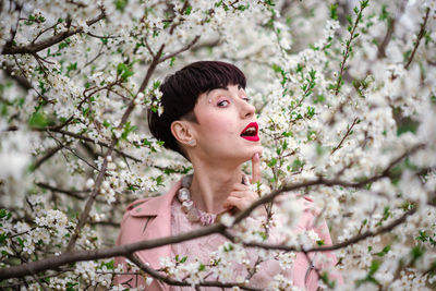 Portrait of a beautiful young woman with cherry blossom