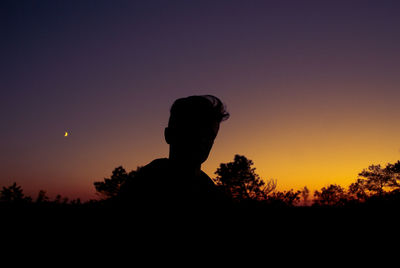 Silhouette man against sky during sunset