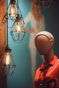 Close-up of illuminated pendant light hanging from ceiling