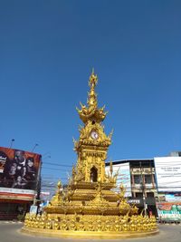 Statue of temple against clear blue sky