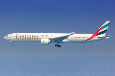 Airplane flying against clear blue sky