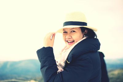 Smiling young woman using mobile phone