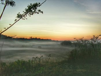 Scenic view of field against sky during sunset