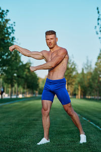 Full length of man exercising on field