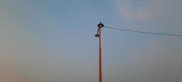 Low angle view of street light against sky