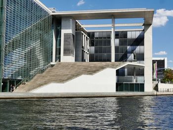 View of swimming pool by building against sky