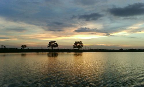 Scenic view of lake at sunset