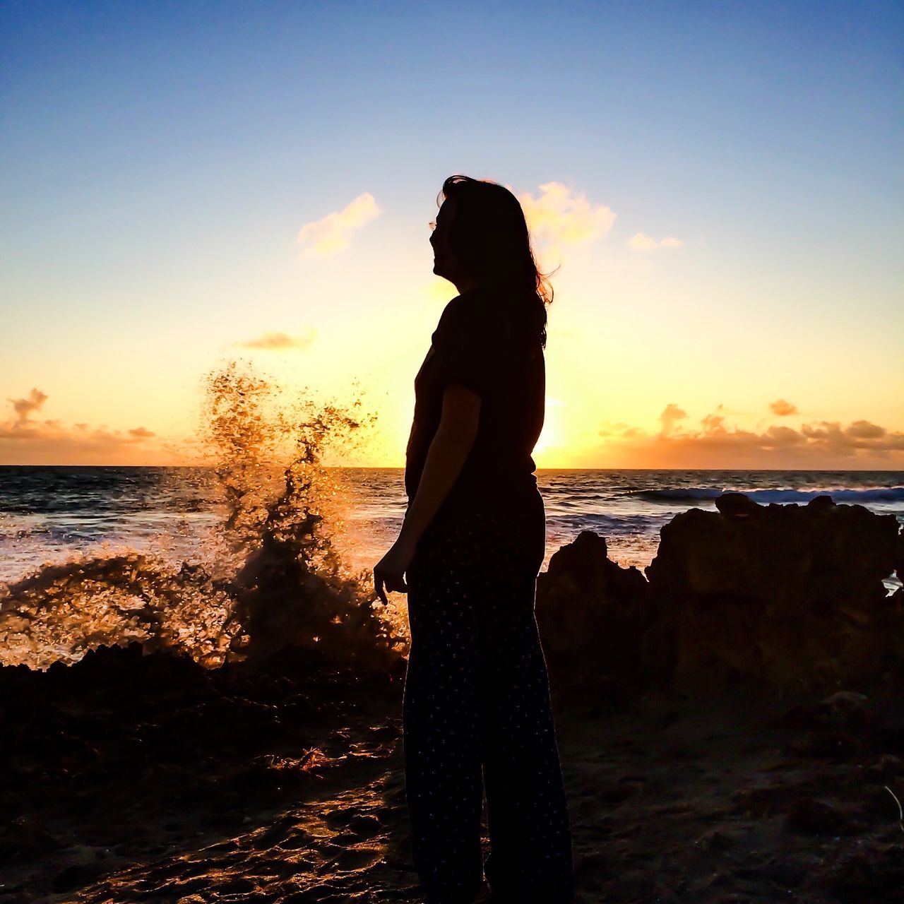 sea, horizon over water, sunset, sky, water, silhouette, beach, standing, tranquility, scenics, beauty in nature, tranquil scene, shore, leisure activity, lifestyles, nature, rear view, orange color