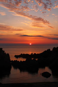 Scenic view of sea against romantic sky at sunset