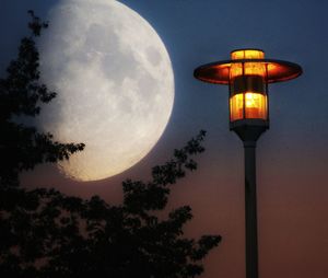 Low angle view of illuminated street light against sky at night