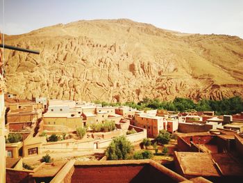 Houses on mountain against clear sky