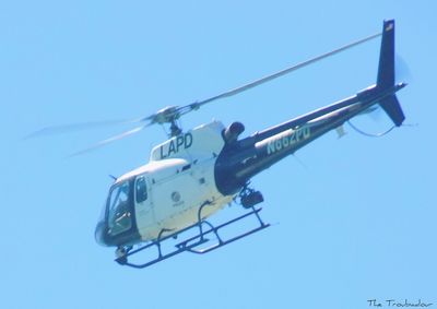 Low angle view of helicopter against clear blue sky