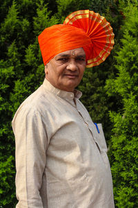 Portrait of man standing against plants