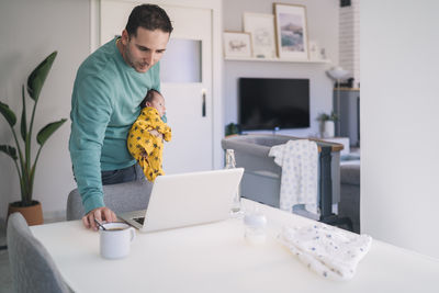 Man using laptop on table