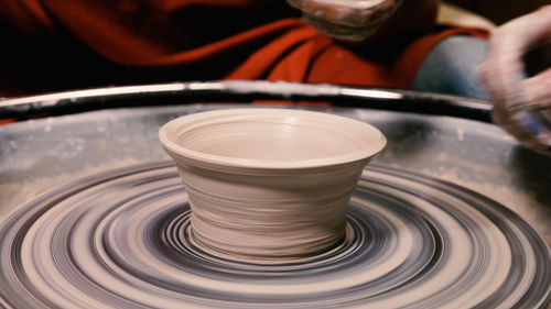 Close-up of a rotating cup blank on a potter's wheel