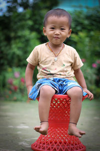 Full length of a boy sitting outdoors