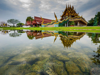 Reflection of building on lake against sky