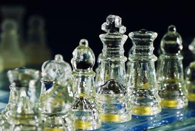 Close-up of glass chess pieces on table