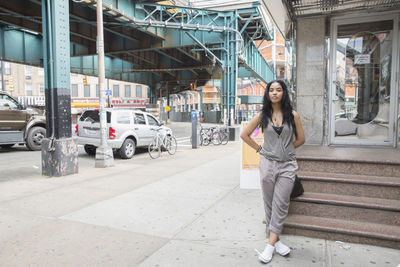 Young woman near a bridge in queens, new york