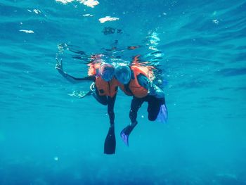 People snorkeling in sea