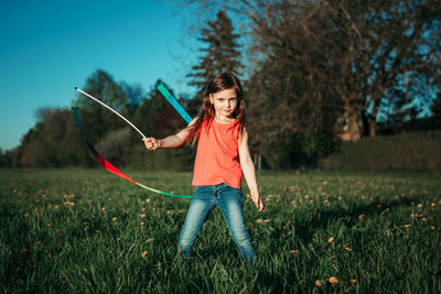 Girl holding umbrella on field