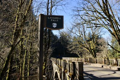 Low angle view of road sign against sky