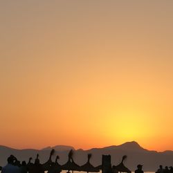 Scenic view of silhouette landscape against orange sky