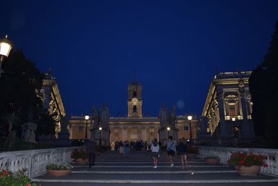 Illuminated building against sky at night