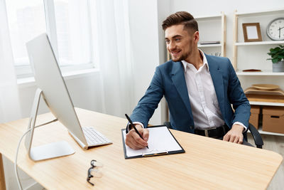 Happy businessman working at office