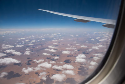 Aerial view of clouds seen through airplane window