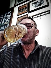 Portrait of man drinking glasses