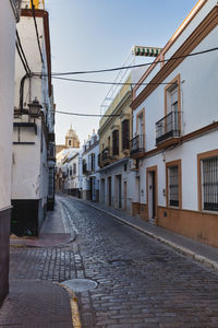 Empty alley amidst buildings in city