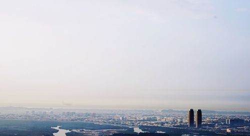 Buildings in city against clear sky