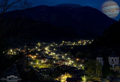 High angle view of illuminated buildings in city at night