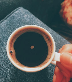 Person holding cup of coffee