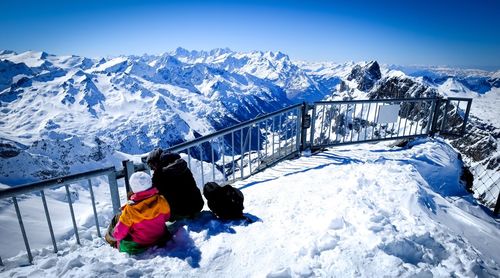 People sitting on top of mt titlis in swiss alps