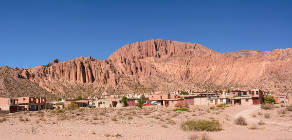 Scenic view of mountains against clear blue sky