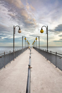 Street light on pier against sky
