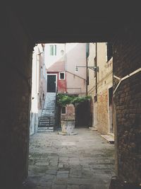 Narrow street leading towards house