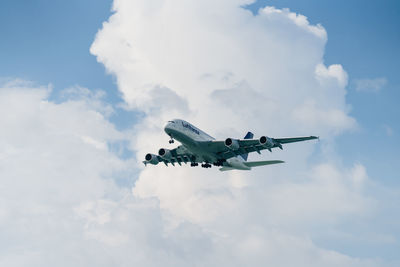 Low angle view of airplane flying in sky