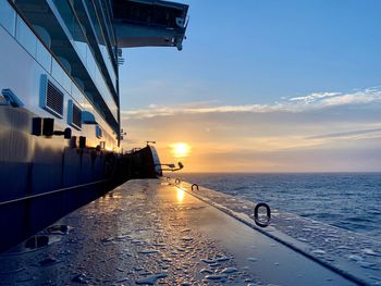 Cruise ship in sea against sky during sunset