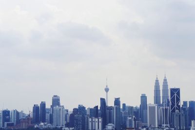 City skyline against cloudy sky