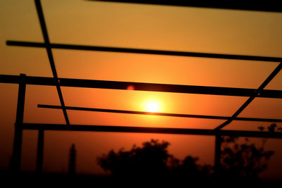 Low angle view of silhouette bridge against sky at sunset