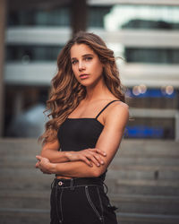 Portrait of beautiful young woman standing outdoors