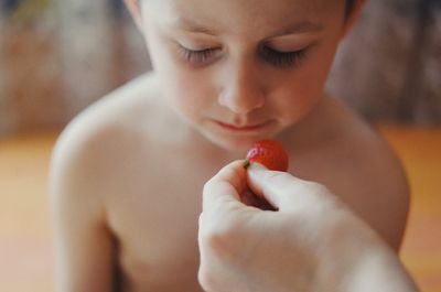 Close-up of boy eating fruit