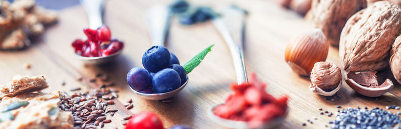 High angle view of fruits and seeds on wooden table