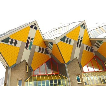 Low angle view of yellow building against clear sky