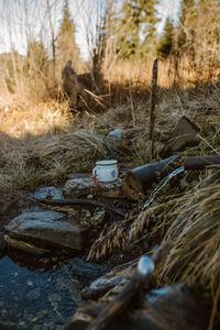 Close-up of abandoned garbage on field